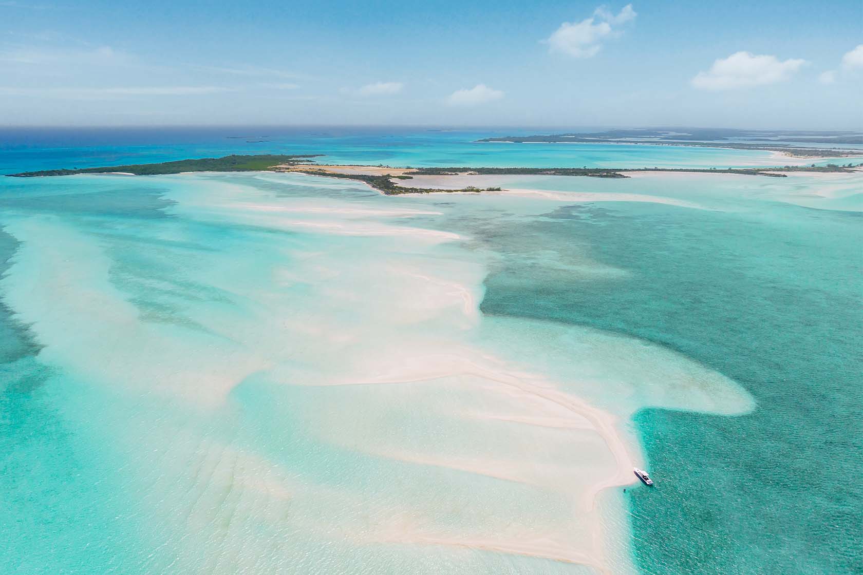 A sweeping white sandbar in the turquoise water of Moriah Harbour