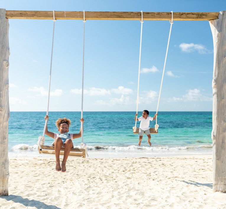 Beach swings beside turquoise water on Grand Bahama