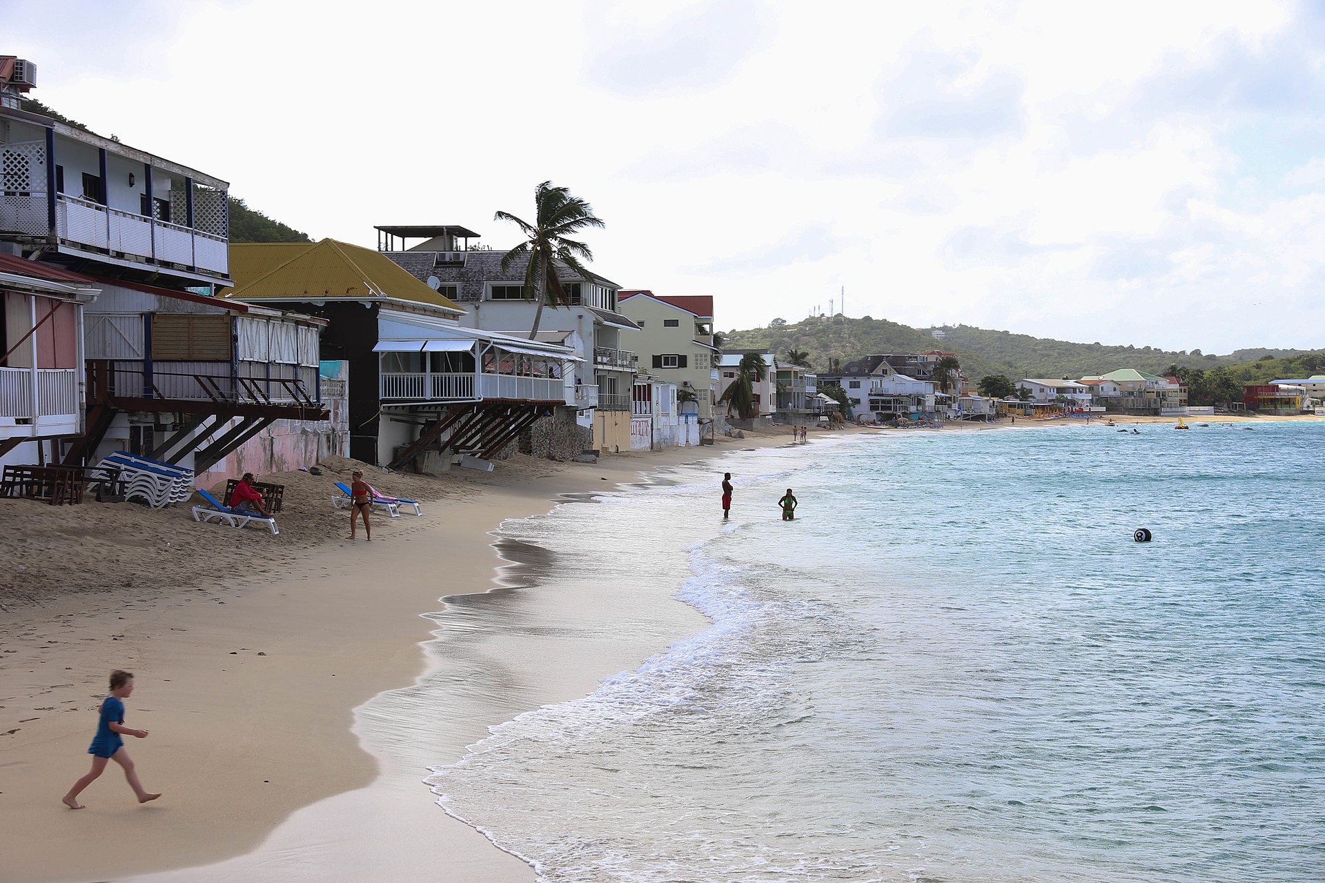 Grand Case Beach curving past the waterfront village on French Saint Martin