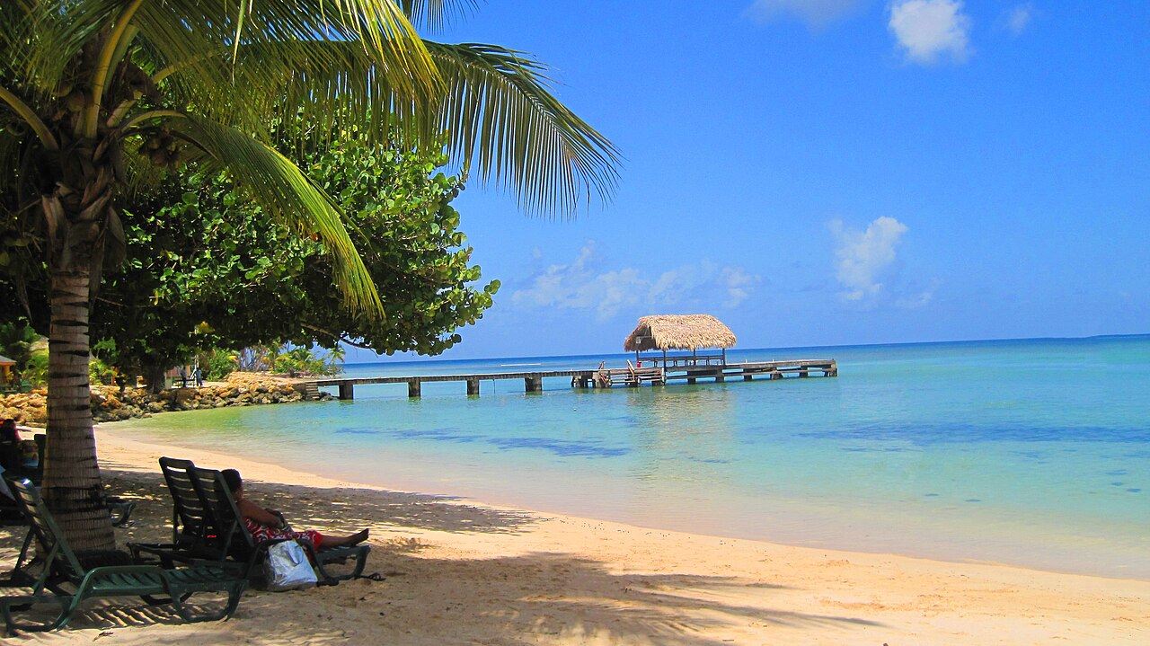 Pale sand, turquoise water and a thatched jetty at Pigeon Point in Tobago